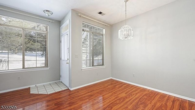 interior space featuring hardwood / wood-style flooring and an inviting chandelier