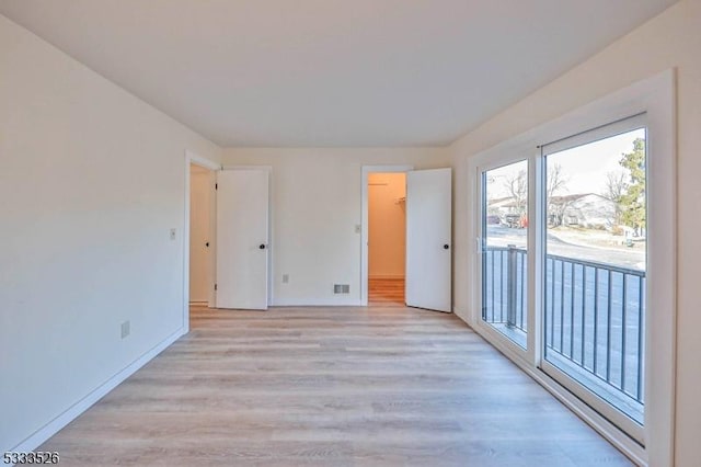 spare room featuring light hardwood / wood-style floors