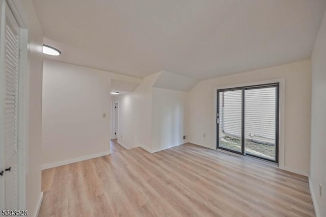 unfurnished room with vaulted ceiling and light hardwood / wood-style floors