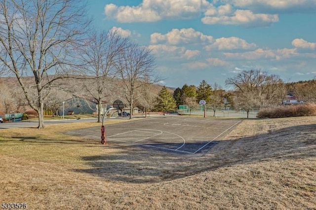 view of basketball court with a lawn