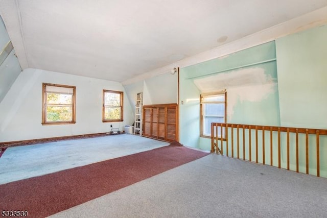 spare room featuring lofted ceiling and carpet flooring