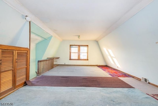 bonus room featuring light carpet, radiator, and lofted ceiling