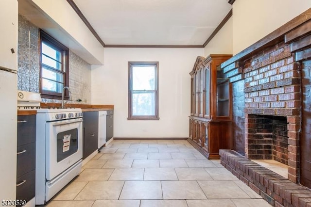 kitchen featuring a brick fireplace, white appliances, light tile patterned floors, and crown molding