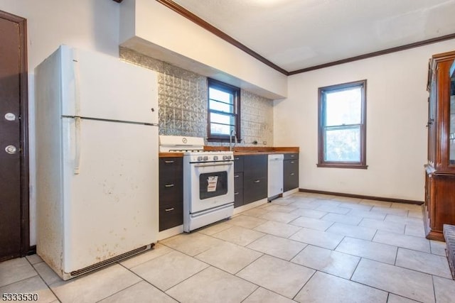 kitchen featuring light tile patterned flooring, white appliances, and ornamental molding