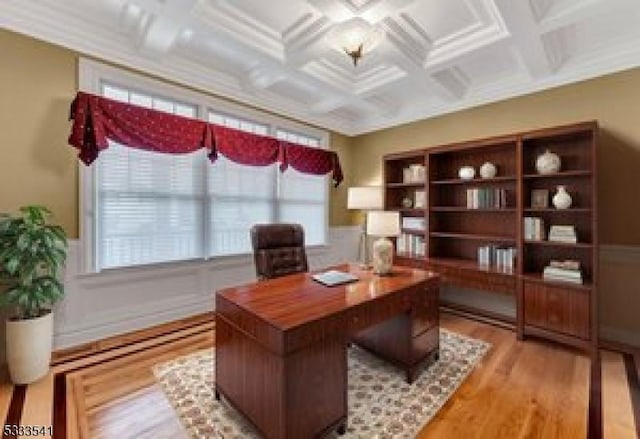 office space featuring beamed ceiling, crown molding, coffered ceiling, and light hardwood / wood-style floors