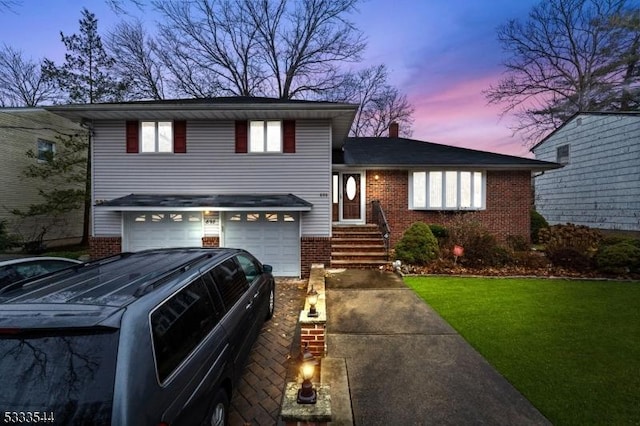 view of front of property with a yard and a garage