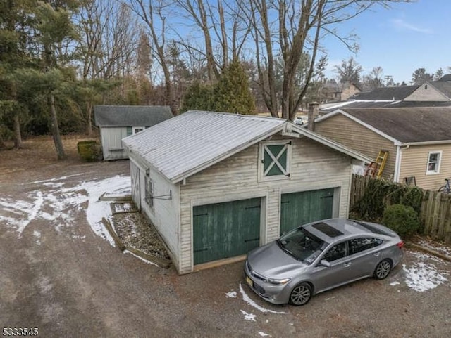 exterior space featuring a garage and an outdoor structure