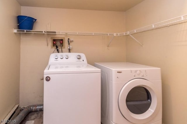 clothes washing area featuring washing machine and clothes dryer