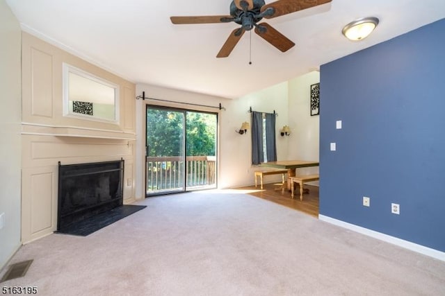 unfurnished living room featuring ceiling fan and light carpet