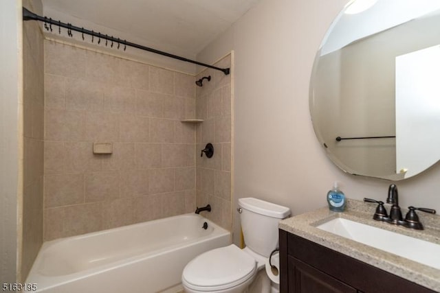 full bathroom featuring vanity, toilet, and tiled shower / bath