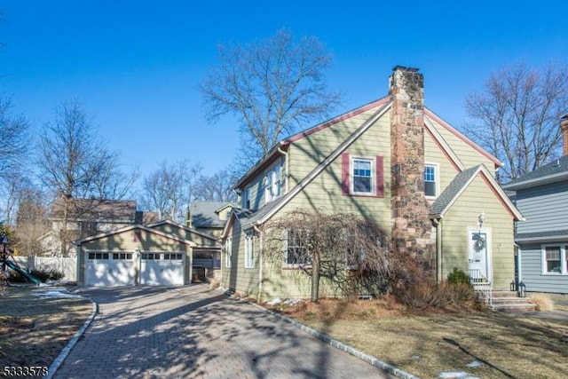 view of front of home with an outdoor structure and a chimney