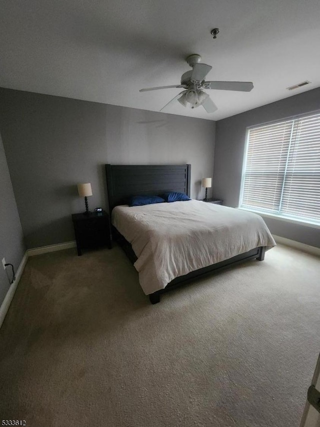 bedroom with ceiling fan and carpet