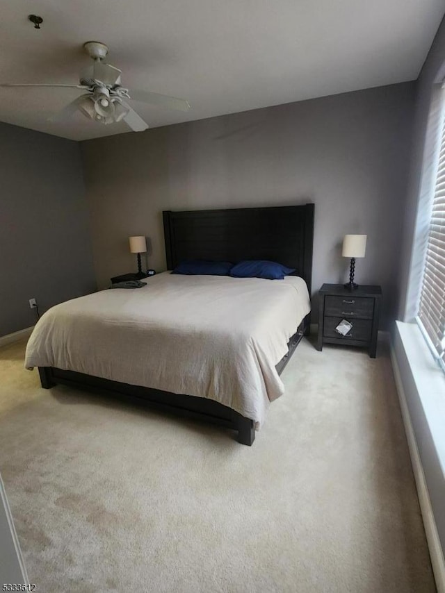 bedroom featuring ceiling fan and carpet