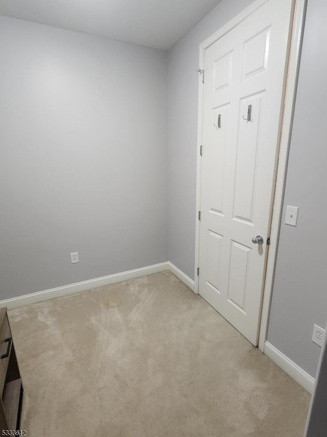 spare room featuring light colored carpet