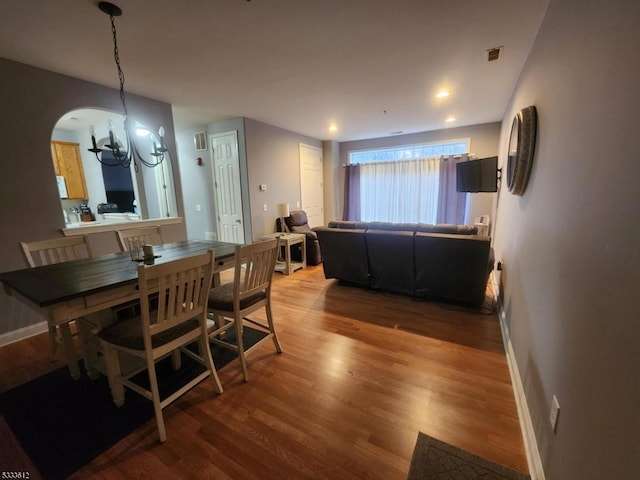 dining area with a chandelier and light hardwood / wood-style floors