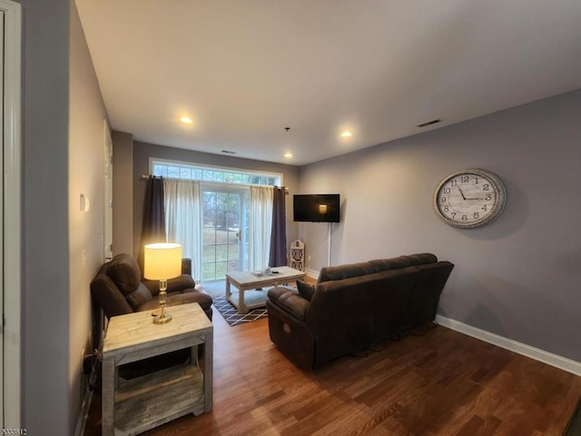 living room featuring dark wood-type flooring