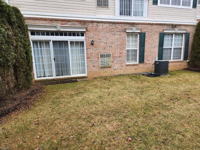 view of home's exterior featuring cooling unit and a yard