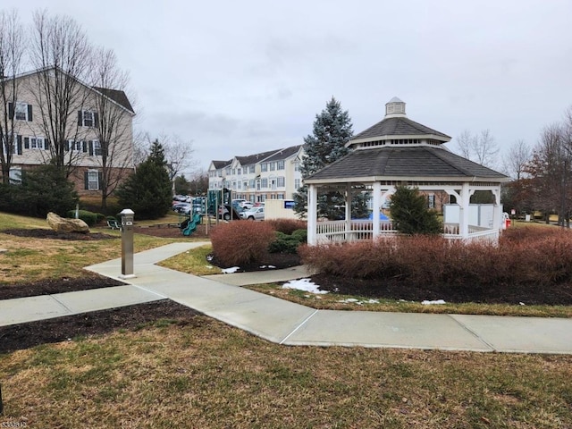 view of community featuring a lawn, a gazebo, and a playground