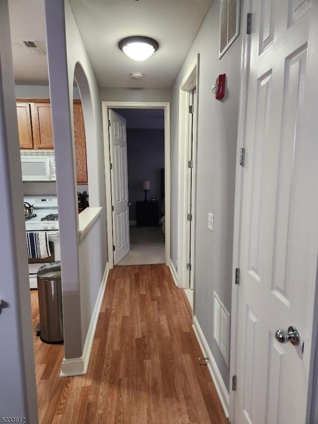 hall with hardwood / wood-style floors