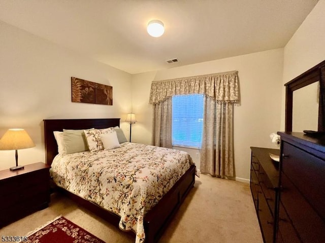 bedroom featuring light colored carpet