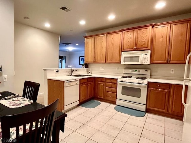 kitchen with sink, white appliances, and light tile patterned flooring