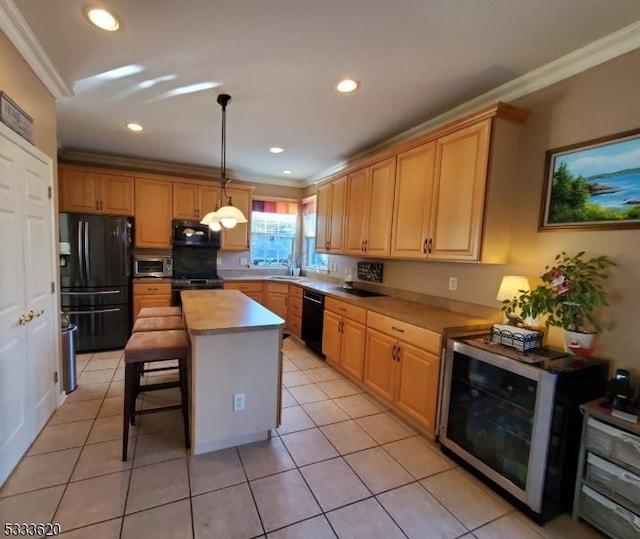 kitchen with pendant lighting, black appliances, a center island, light tile patterned flooring, and ornamental molding