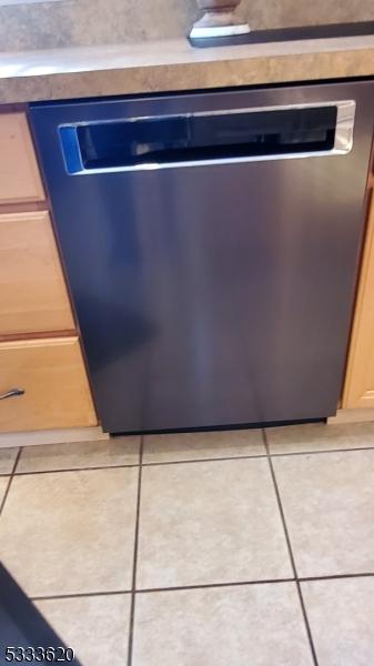 interior details featuring dishwasher and light brown cabinets