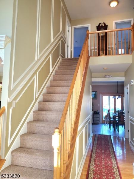 stairs featuring hardwood / wood-style floors