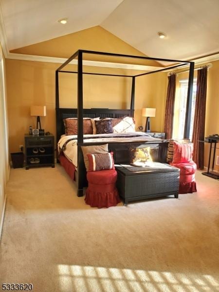 bedroom with ornamental molding, lofted ceiling, and carpet floors