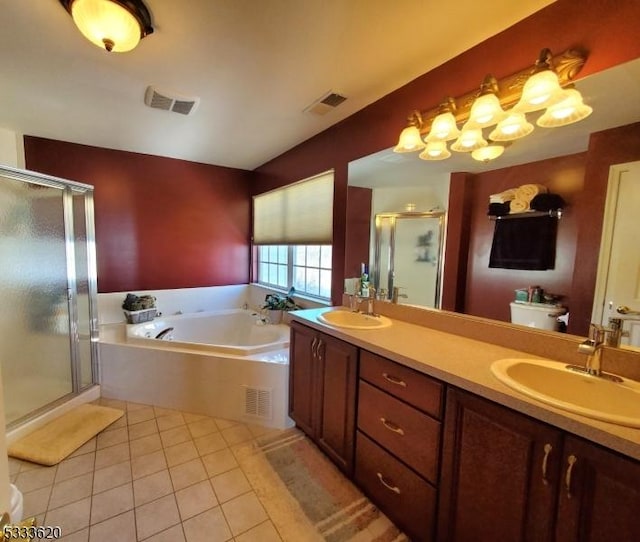 bathroom featuring vanity, independent shower and bath, and tile patterned flooring