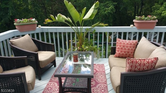 wooden balcony with an outdoor living space and a deck