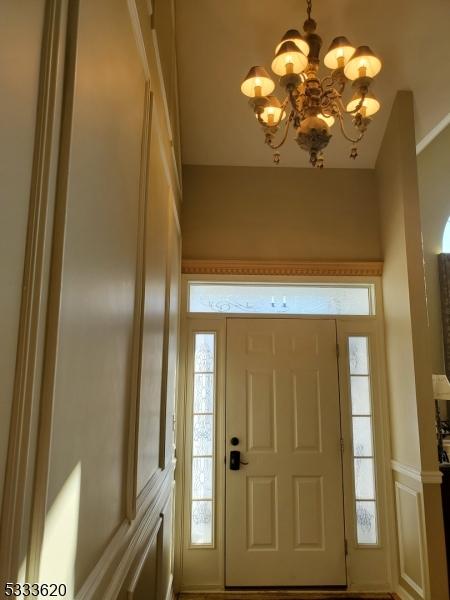 foyer with a chandelier