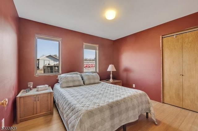 bedroom featuring a closet and light wood-style floors