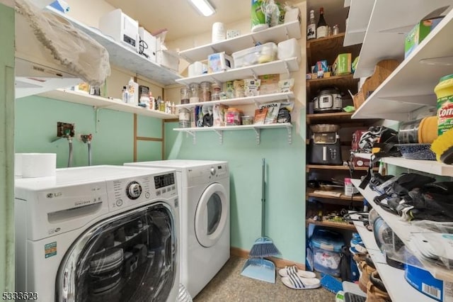 laundry room with laundry area and washing machine and clothes dryer