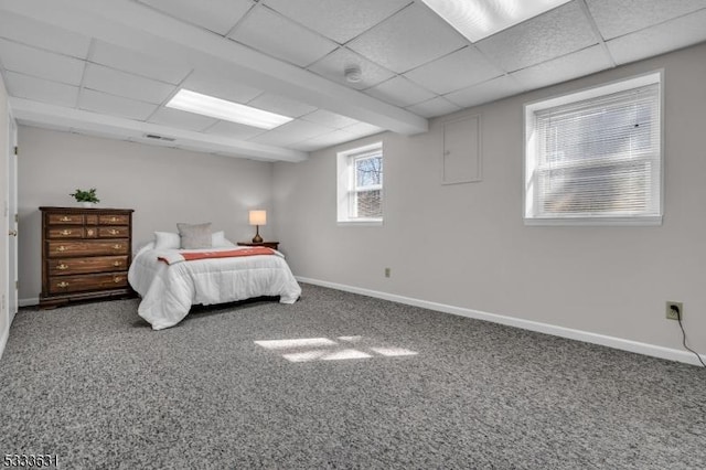 carpeted bedroom with a paneled ceiling and baseboards