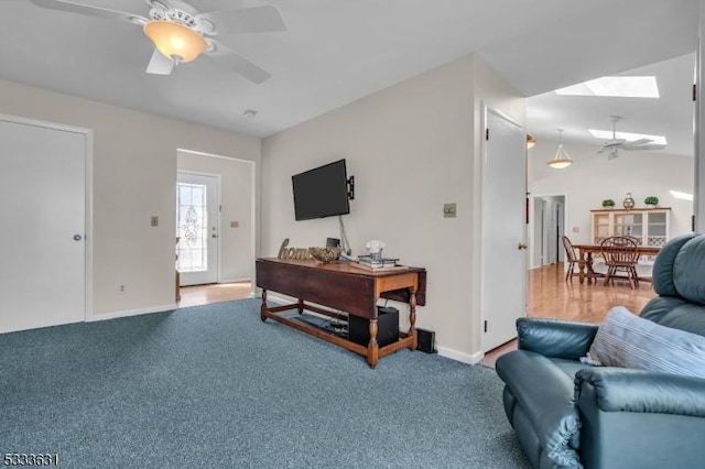 interior space with lofted ceiling, ceiling fan, and baseboards