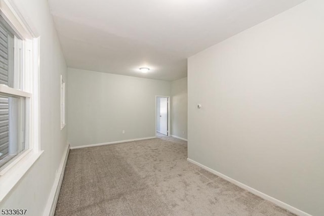 unfurnished room featuring light carpet