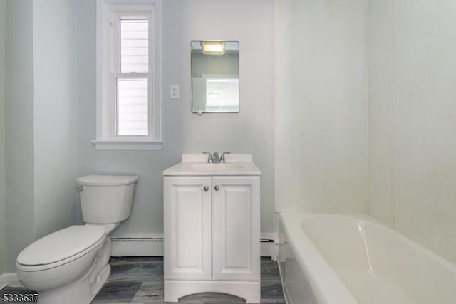 bathroom with vanity, toilet, a wealth of natural light, and a baseboard radiator