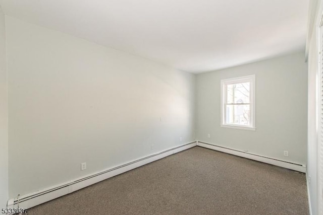 empty room featuring baseboard heating and carpet flooring