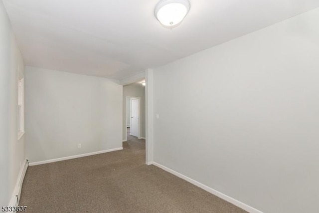 carpeted spare room with baseboard heating