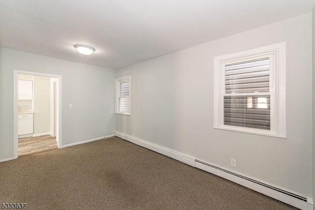 carpeted spare room with baseboard heating