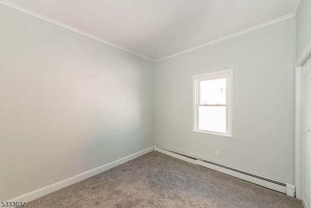 carpeted empty room with crown molding and a baseboard heating unit