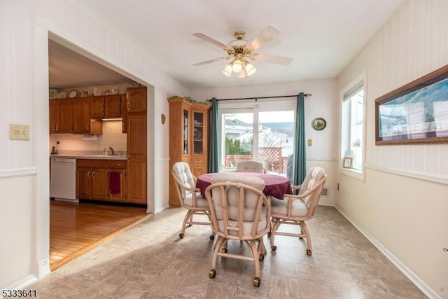 dining room with ceiling fan and sink