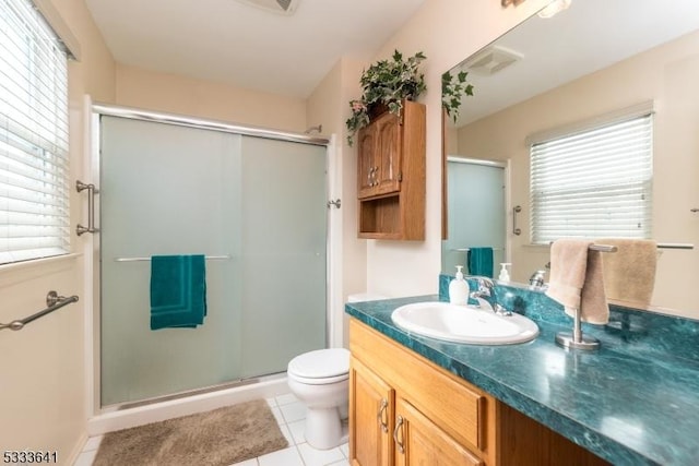 bathroom with toilet, vanity, tile patterned floors, and walk in shower