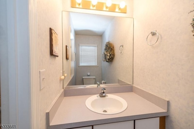 bathroom featuring vanity and toilet