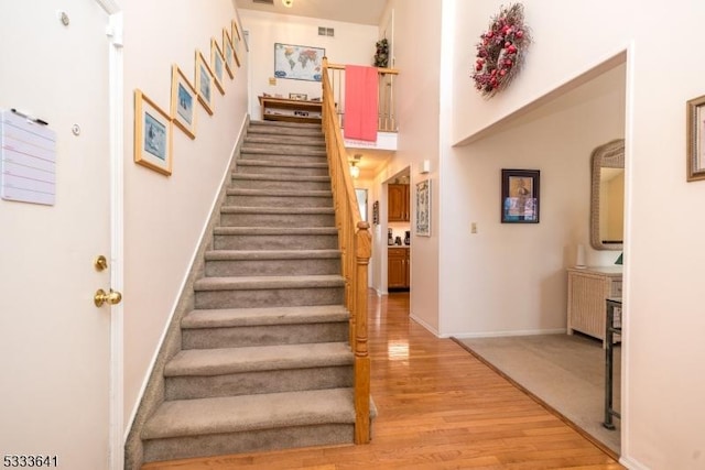 staircase with wood-type flooring