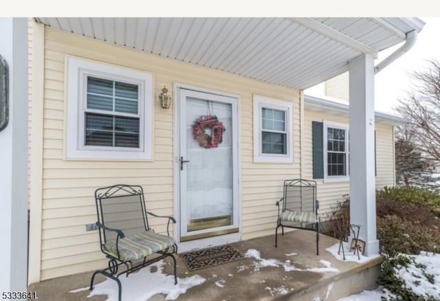 view of snow covered property entrance