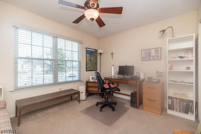 home office with ceiling fan and light colored carpet