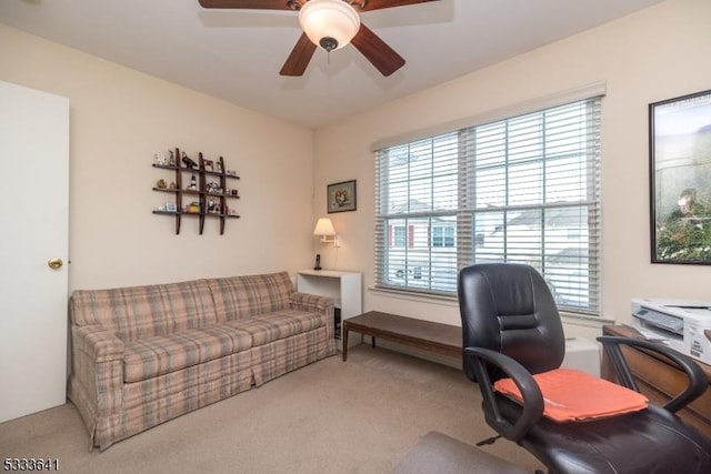 office featuring ceiling fan, light colored carpet, and a healthy amount of sunlight