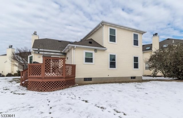 snow covered house featuring a deck